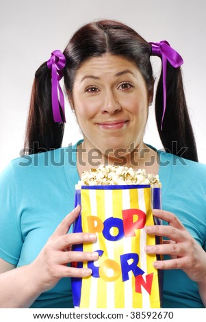 Fat young woman eating popcorn,young woman eating popcorn,