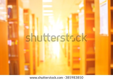 blur image of the library or Book shelf Knowledge and Research in Education  sun light