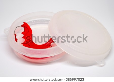 red retainer in the box isolated on white