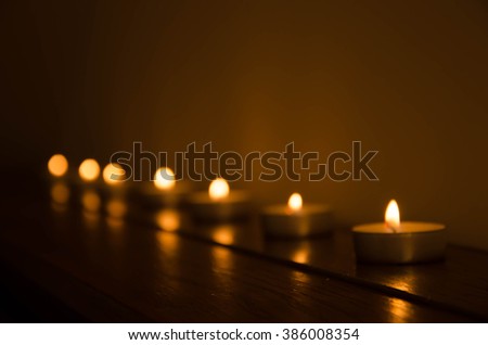 Artistic abstract blur background with church candles in the dark