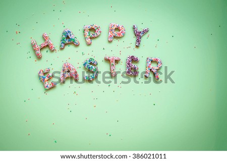 Colorful Easter homemade gingerbread cookies in form of words Happy Easter on a light green background. Delicious Easter cookies background with space for text. Copy space.