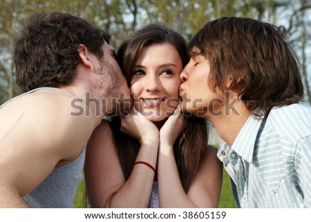 Happy girl kissed by two young boys Royalty-Free Stock Photo #38605159