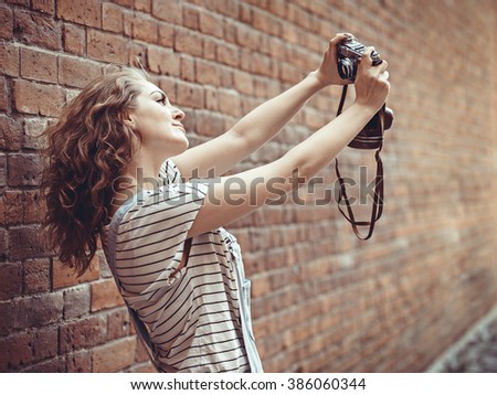 Beautiful girl making selfie with camera  in park, instagram
