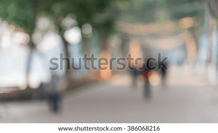 Blurred motion people jogging, walking or running in early morning on the bank of Hoan Kiem Lake, Hanoi, Vietnam. Abstract blurry urban outdoor exercise/workout background. Healthy lifestyle concept.