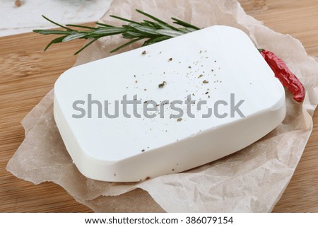 Feta cheese piece on the wood background
