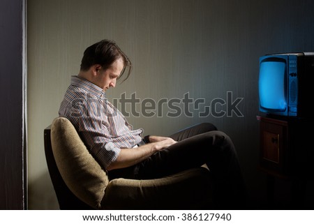 Man falling asleep in front of the TV