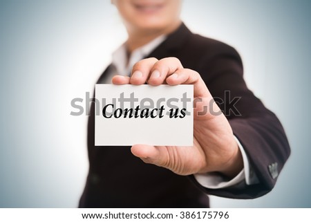 Contact us  message word on card in hand of Friendly man hand and smiling