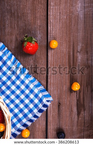 berries and wild herbs on a wooden background
