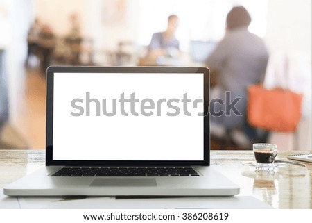 Soft picture for feeling relax laptops on desk in workspace coffee cafe with morning light and blur team discussion background.
