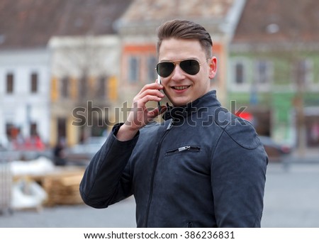 Picture of a handsome young man talking on mobile phone