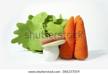 Plush toy vegetables. Fake varied vegetables: mushroom, cabbage, carrots. Kids vegetable toys.