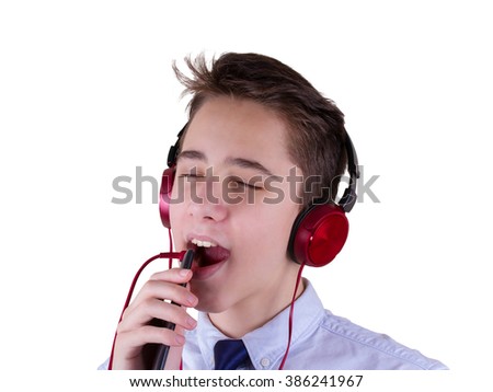 Singing teen boy in headphones listening to music and showing hand sign isolated on white background