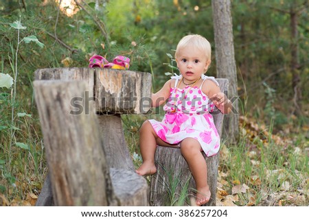 The child, a little girl playing in the woods, summer vacation, in anticipation of a meal in a Fairy Tale.