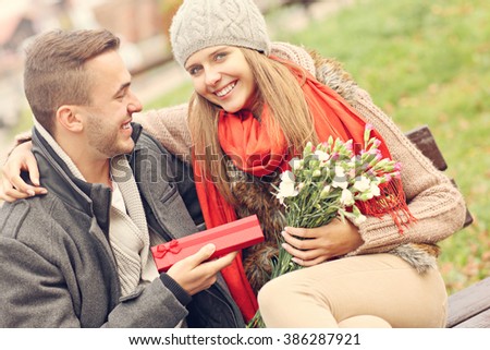 Picture of romantic couple with presents in the park