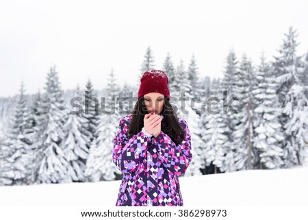 young and beautiful girl posing and enjoying the snow