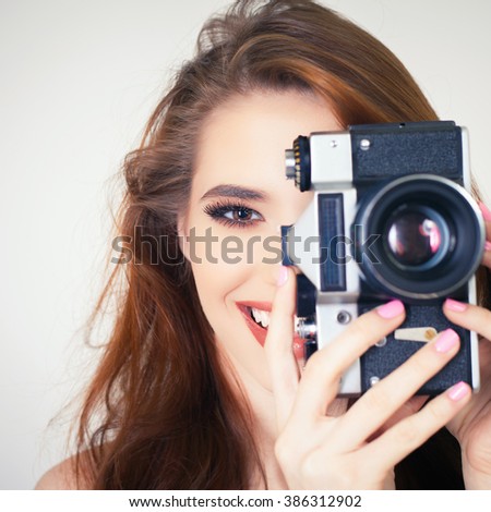 Image of cute girl make a foto selfie at vintage camera. Take a photograph of himself. Funny, party. Beauty. Happy girl smiling. Makeup and hairstyle