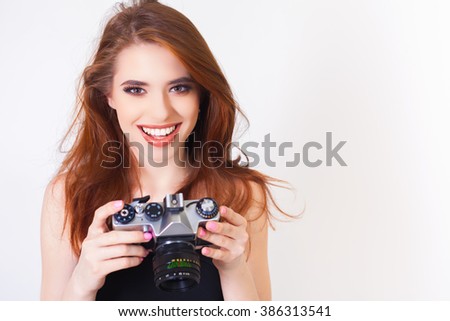 Image of cute girl with vintage camera.