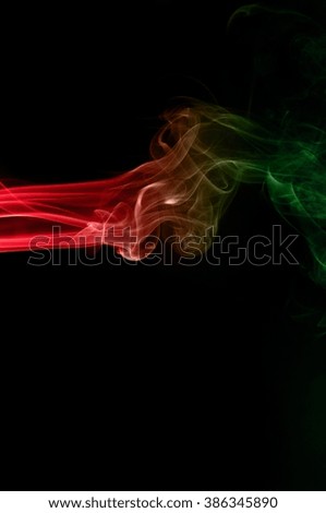 movement of smoke red and green on black background ink beautiful