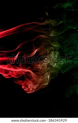 movement of smoke red and green on black background ink beautiful