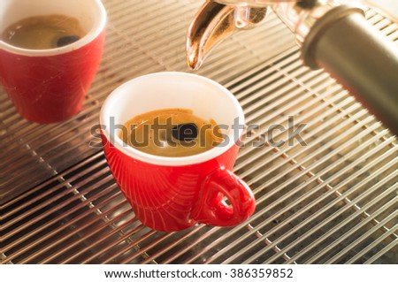 Fresh brew hot coffee from espresso machine with vintage filter effect, stock photo