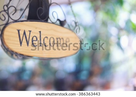 wood welcome sign hanging. selective focus.