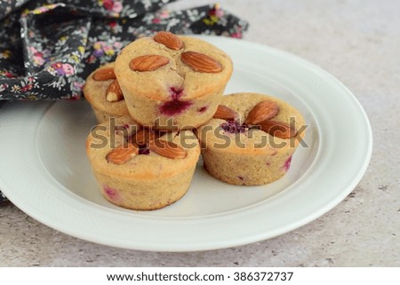 Homemade muffins with almonds on a plate
