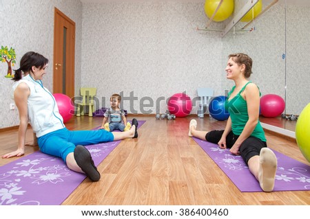 Yoga for woman and child. Mother coach and kid doing fitness exercises