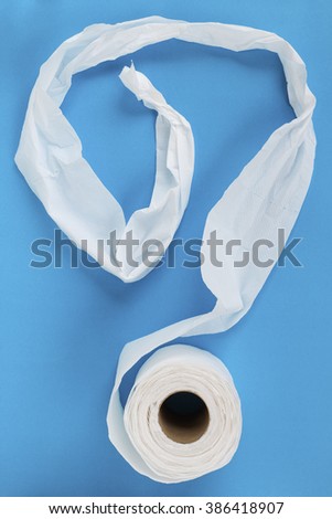 Tissue paper roll on the blue background.Look like question mark.