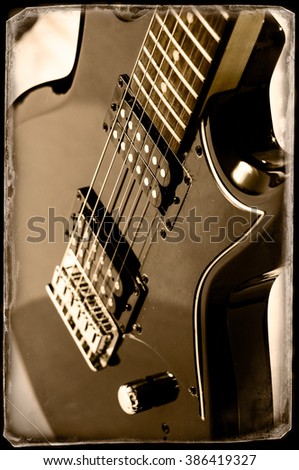 Part of electric guitar on wooden background. Old style.