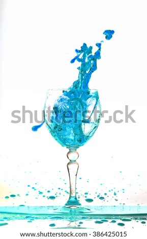 blue wine splash in the glass on white background,blue water drop splash on white background