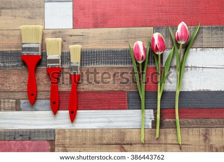 bouquet of tulips and colorful brushes on the color background