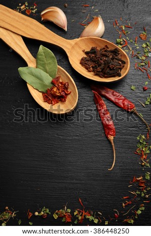 Different spices and spoons on wooden table