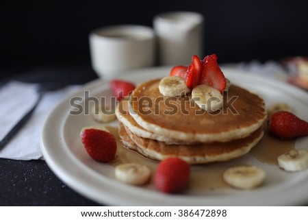pancakes with strawberries and bananas chunks.