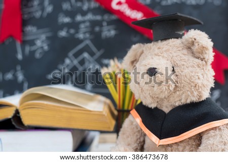 Teddy bear graduate reads a book.back to school.education concept. graduation background.