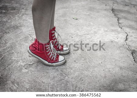 still life of red sneakers on street
