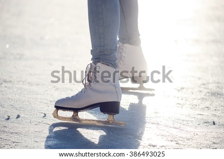 Closeup of young girl on the  figure skates outdoor in sunny spring day