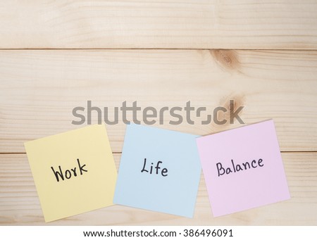 Word "Work Life Balance" on colorful note paper with wood background