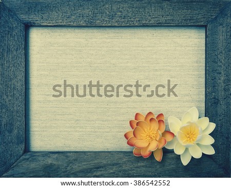 Vintage style wooden frame and flowers on canvas background