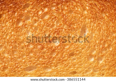 Close up roasted bread background texture. Macro photo Royalty-Free Stock Photo #386551144