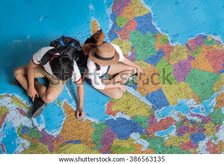 The tourist Planning a tour around the world Royalty-Free Stock Photo #386563135