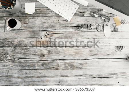 Top view of wooden desktop with a cup of coffee, keyboard and office tools. Mock up