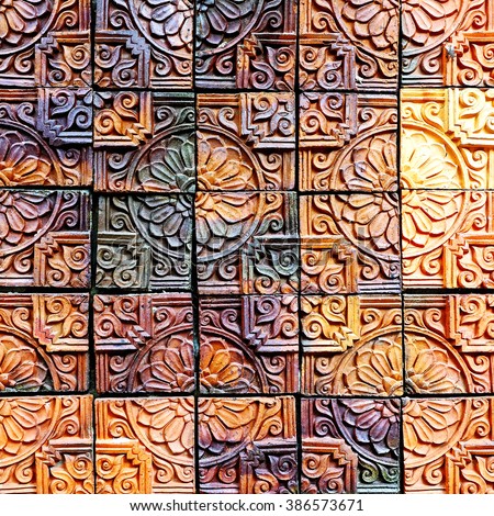 Old vintage earthenware wall  tiles patterns handcraft from thailand public. Royalty-Free Stock Photo #386573671