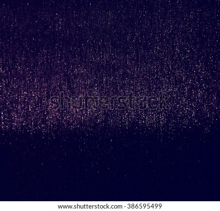 glitter vintage lights background. purple and black. defocused.
