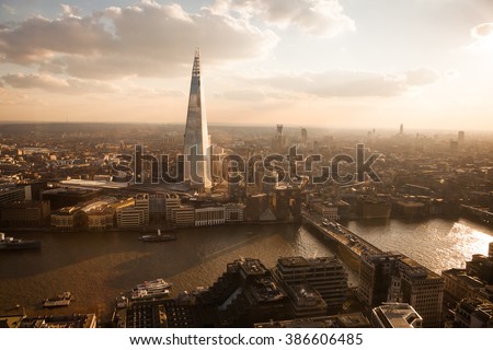 London skyline in front of The Shard at sunset. Vintage style and reflection applied.