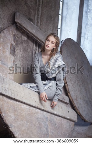 Modern woman in a grey dress.