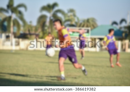 blurry,motion blur,Players in action playing football  (soccer)