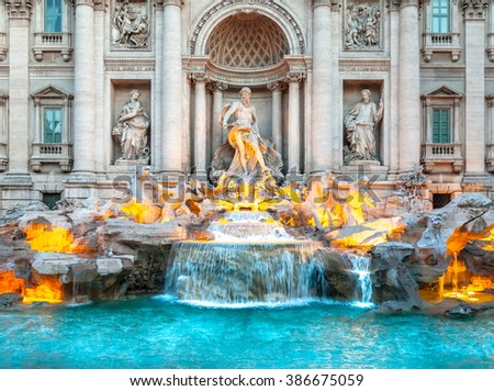 Trevi fountain at sunrise, Rome, Italy. Rome baroque architecture and landmark. Rome Trevi fountain is one of the main attractions of Rome and Italy Royalty-Free Stock Photo #386675059