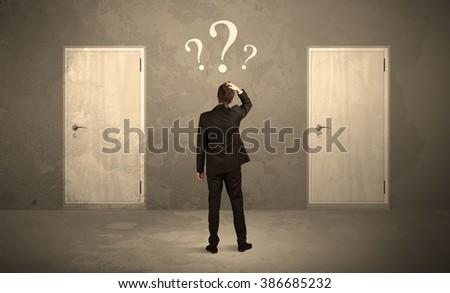 Salesman standing in front of two doors, unable to make the right decision concept with question marks above his head Royalty-Free Stock Photo #386685232
