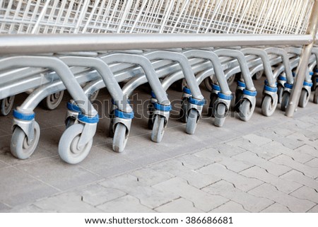 Row of supermarket shopping cart trolleys