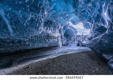 Blue glacier cave in Iceland Royalty-Free Stock Photo #386694067